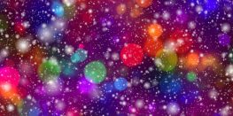 Abstract composition of colorful bokeh lights against a starry purple and red background.