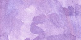 Watercolor texture in shades of lavender and purple on a paper surface.